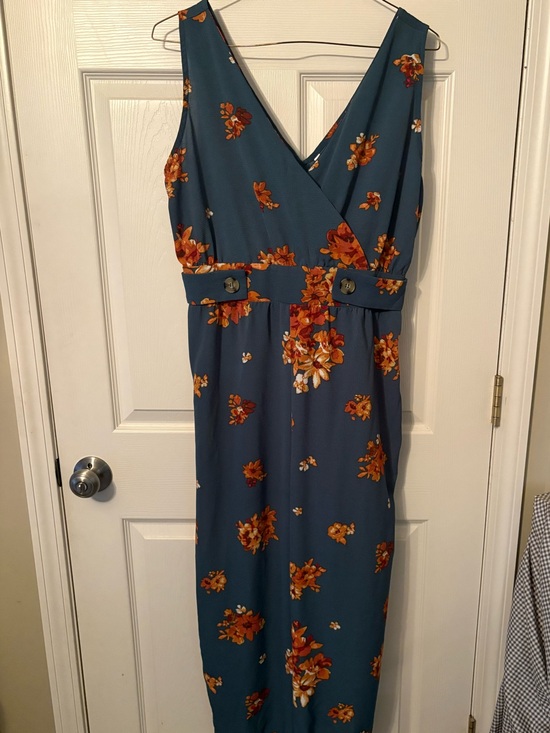 Pants - Sleeveless Teal Floral jumpsuit with button detail on waist.